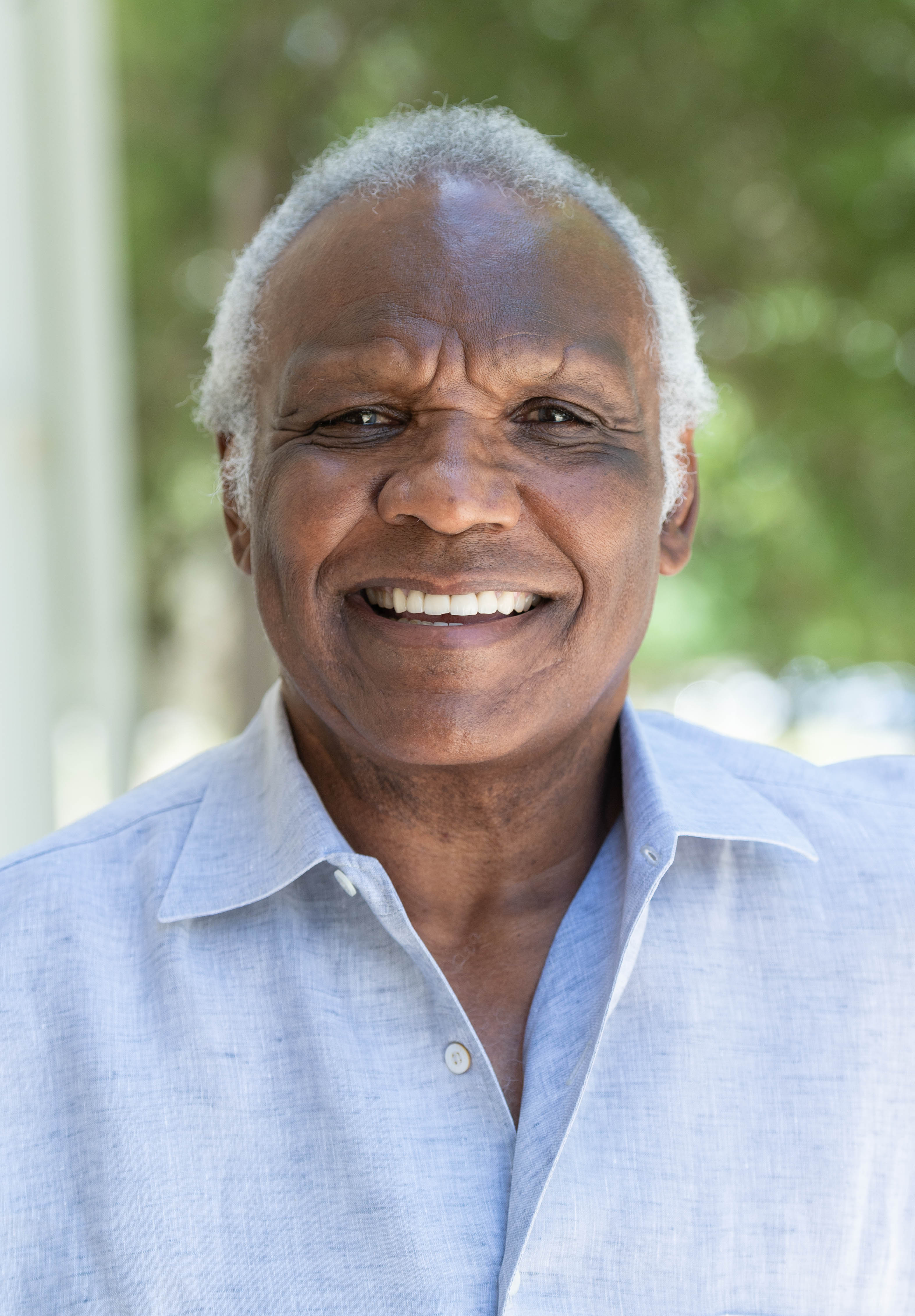 Man smiling. Waring a dark blue shirt